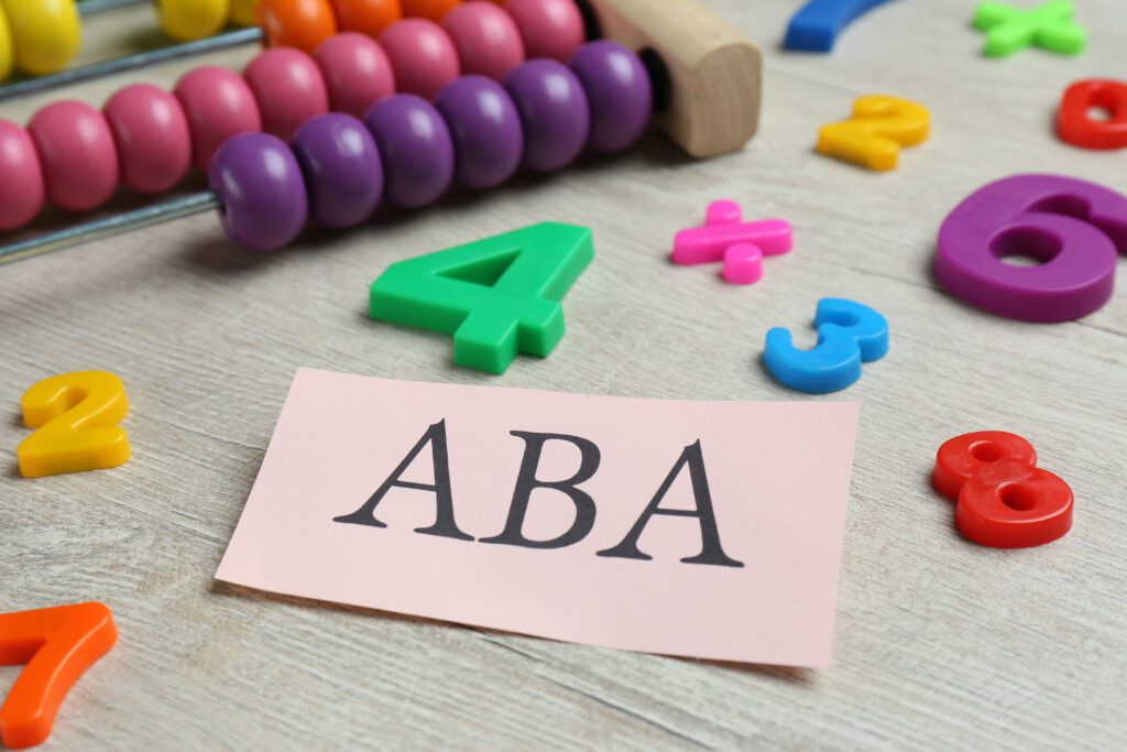 Paper sheet with ABA therapy on it with abacus and colorful numbers