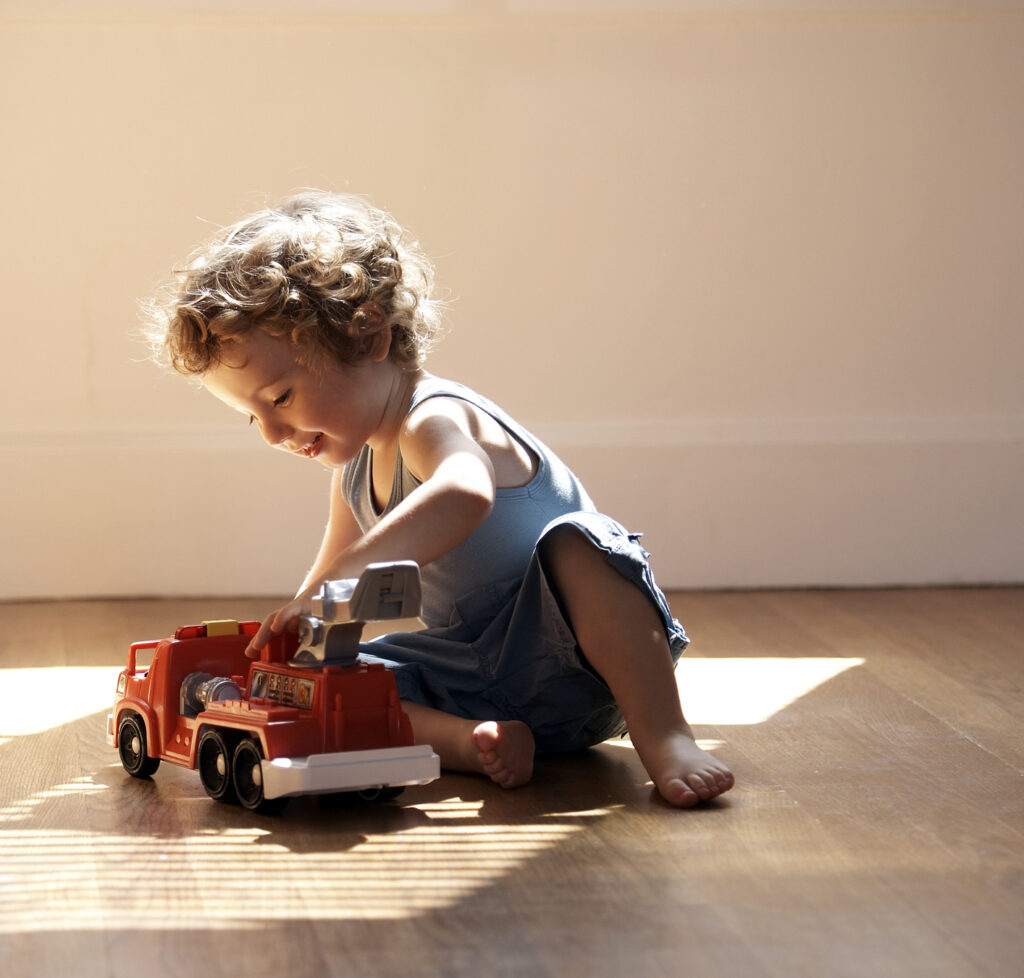 boy playing in autism treatment center with a truck