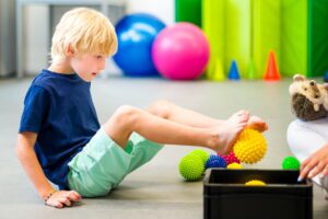 young boy doing occupational therapy with aba therapy