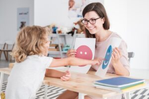 ABA autism therapy therapist working with an autistic child