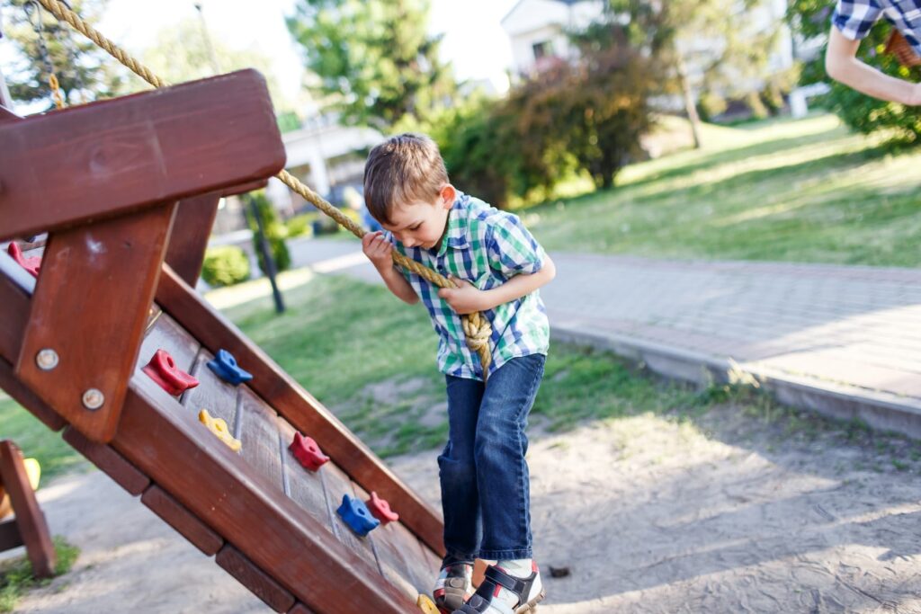 child with autism playing on a playground